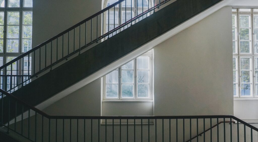 Large staircase in front of bay window